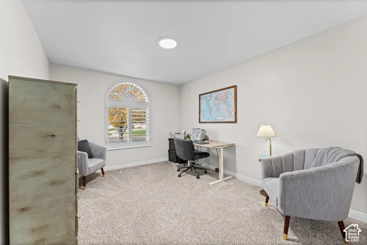 Arched window with plantation shutters, vaulted ceiling, and recessed lighting