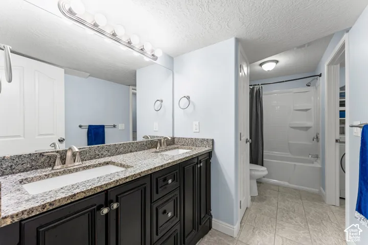 Dual vanity with a speckled countertop, integrated sinks, and brushed nickel fixtures