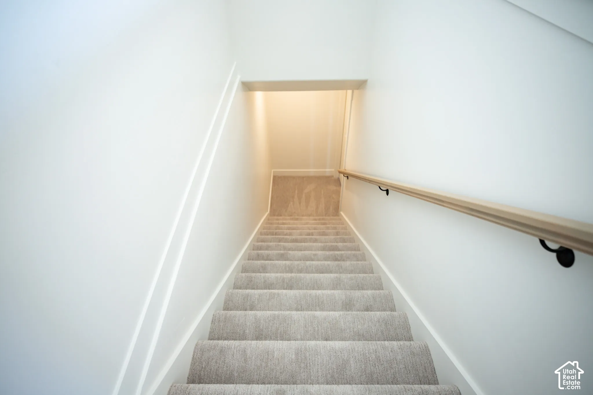 Finished stairway to unfinished basement.