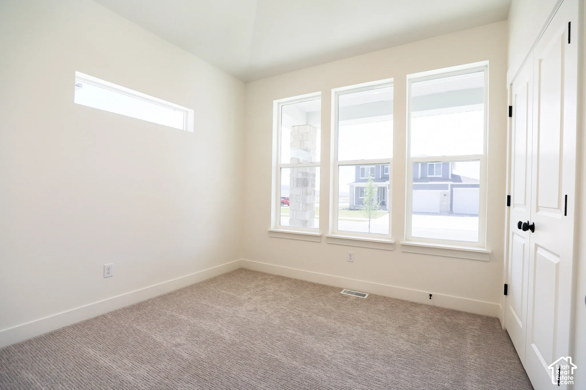 Bedroom #3 with vaulted ceiling and ceiling fan.