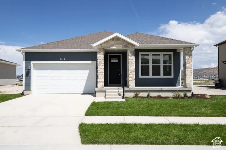 Granite Elevation B with extended porch, open space bordering rear boundary and front yard landscaping installed.
