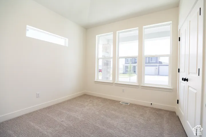 Bedroom #3 with vaulted ceiling and ceiling fan.