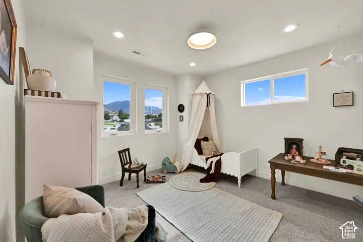 Recessed lighting, three windows, and a ceiling light feature
