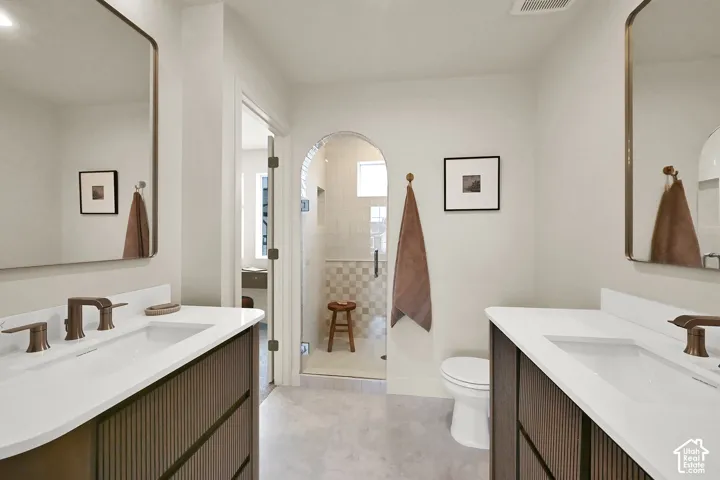 Dual vanities with integrated sinks and bronze-finish fixtures