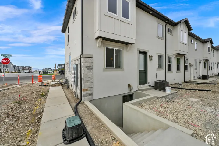 Walk Out Basement Multi-level exterior with light-colored stucco and stone veneer accents