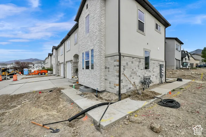 Stone veneer and stucco exterior with multiple windows