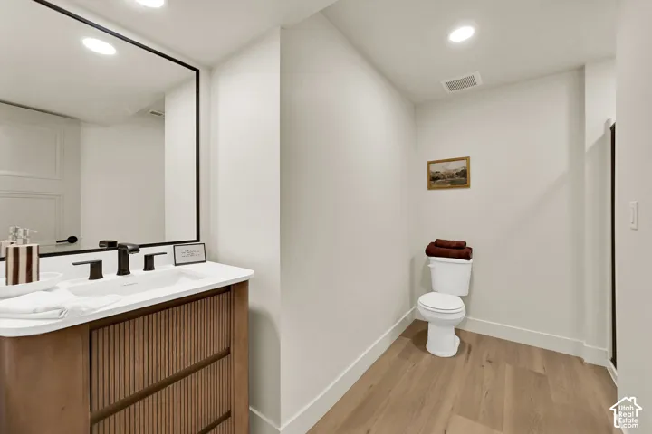 White vanity with an integrated sink, matte black faucet, and a rectangular framed mirror