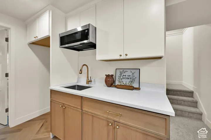 White upper cabinetry with gold-toned hardware