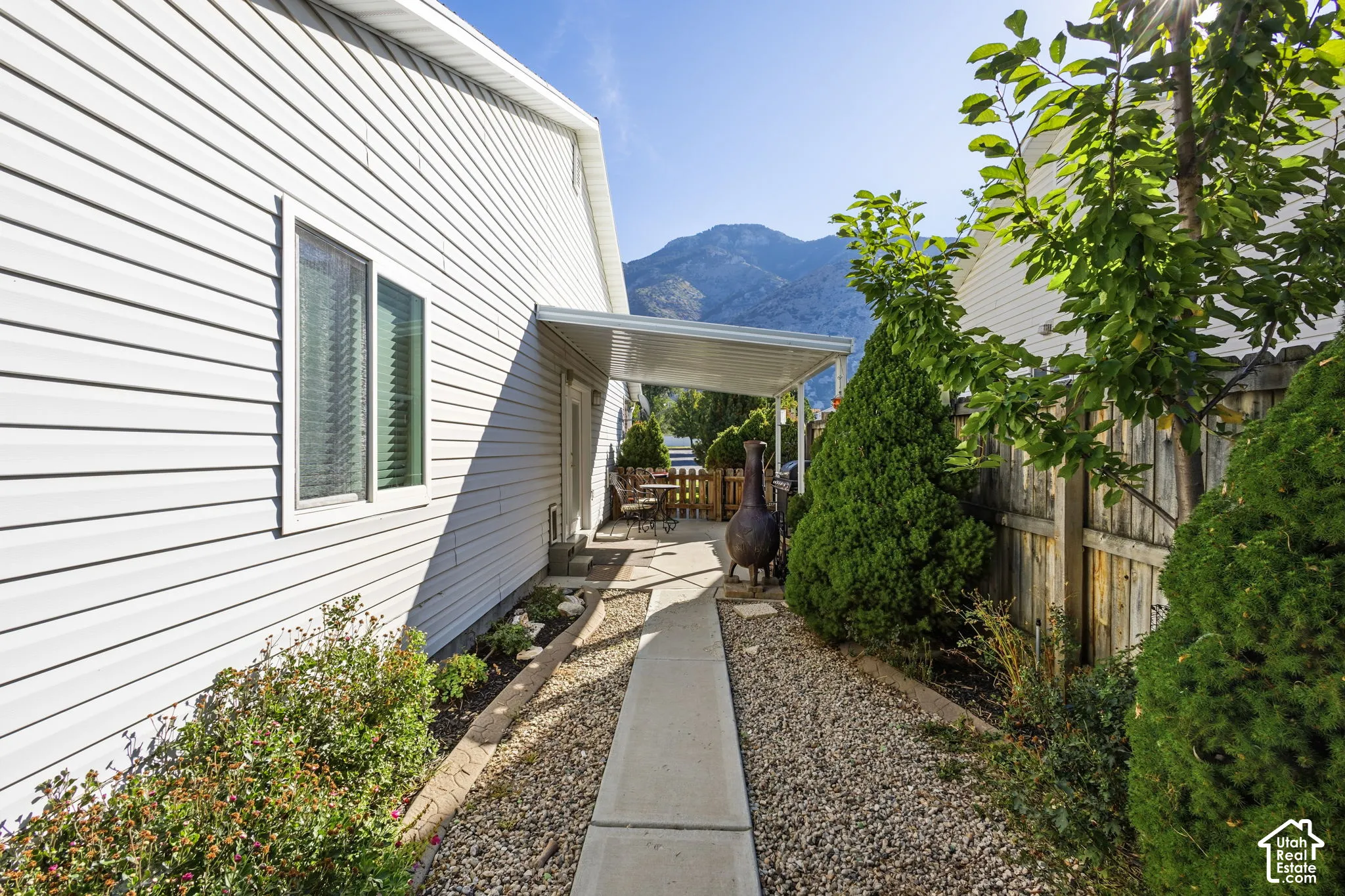 Siding exterior with a darling, private covered patio area