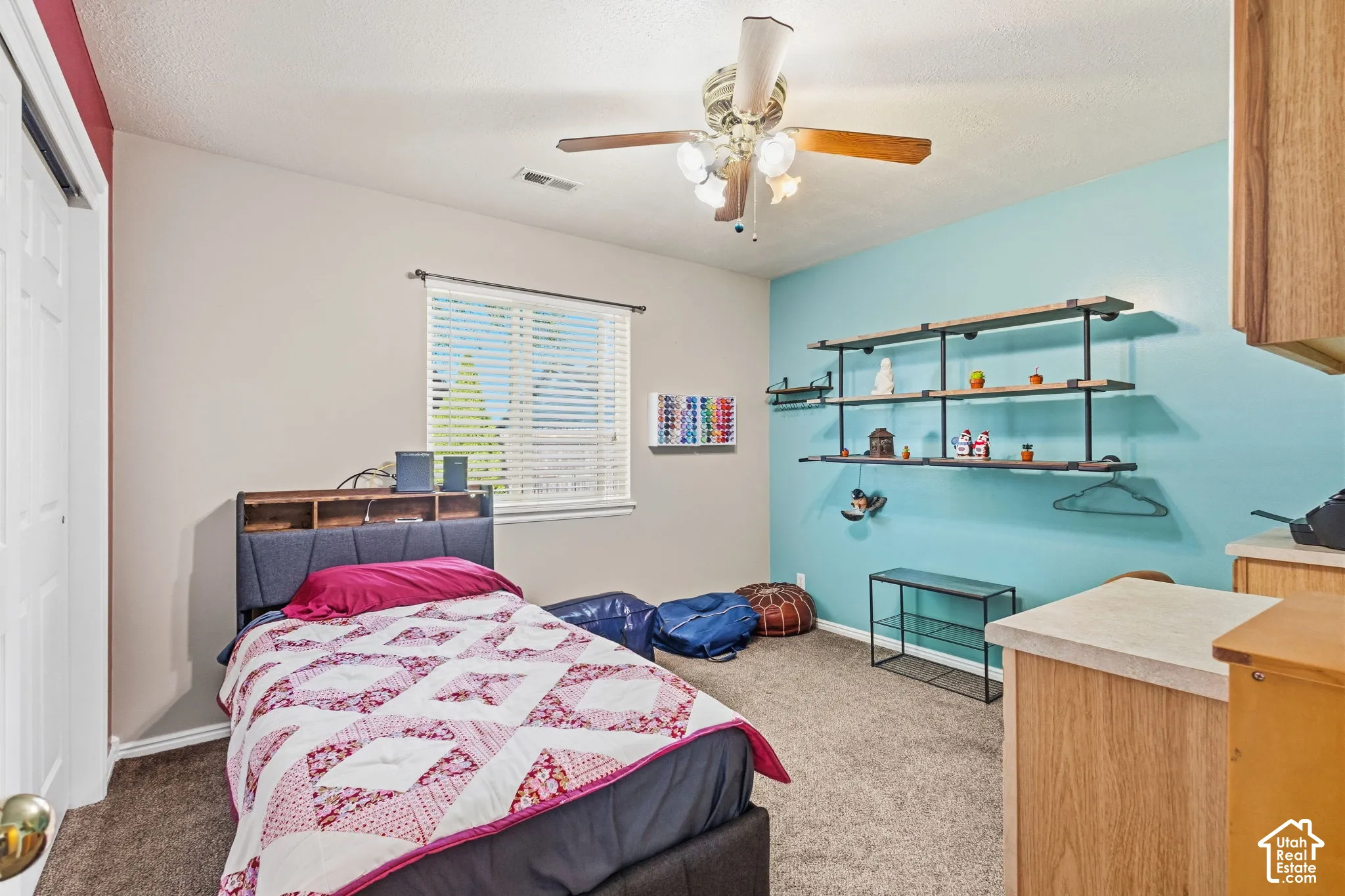 Bedroom featuring built-in shelving, a ceiling fan, and built-in cabinetry