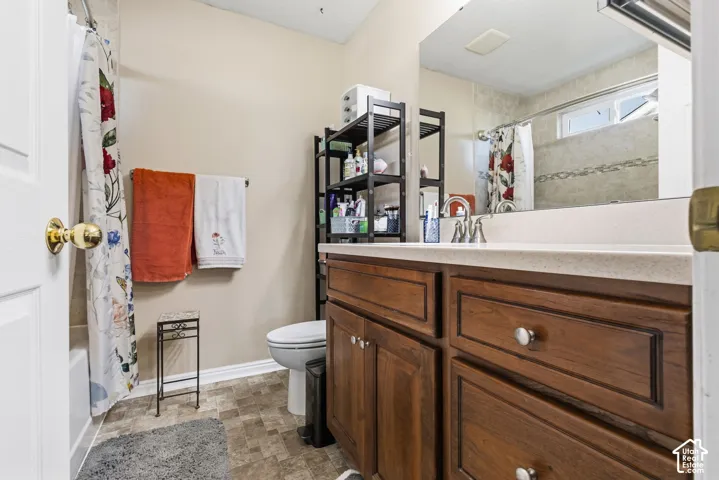 Wood-finish vanity with a light-toned countertop and integrated sink