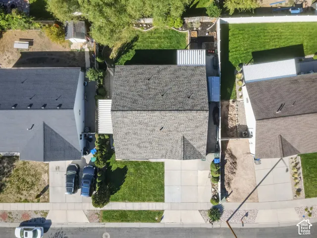 New asphalt shingle roofing, paved driveway, concrete sidewalks, landscaped front yard, and a fenced backyard