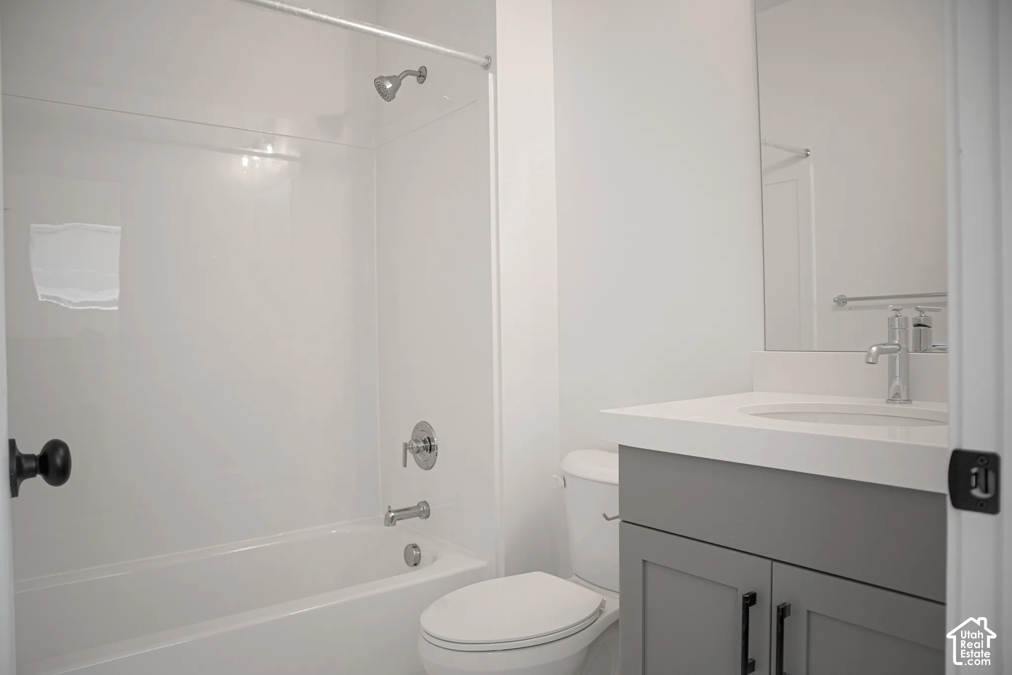 Full secondary bath with painted wood cabinet and quartz slab countertop.