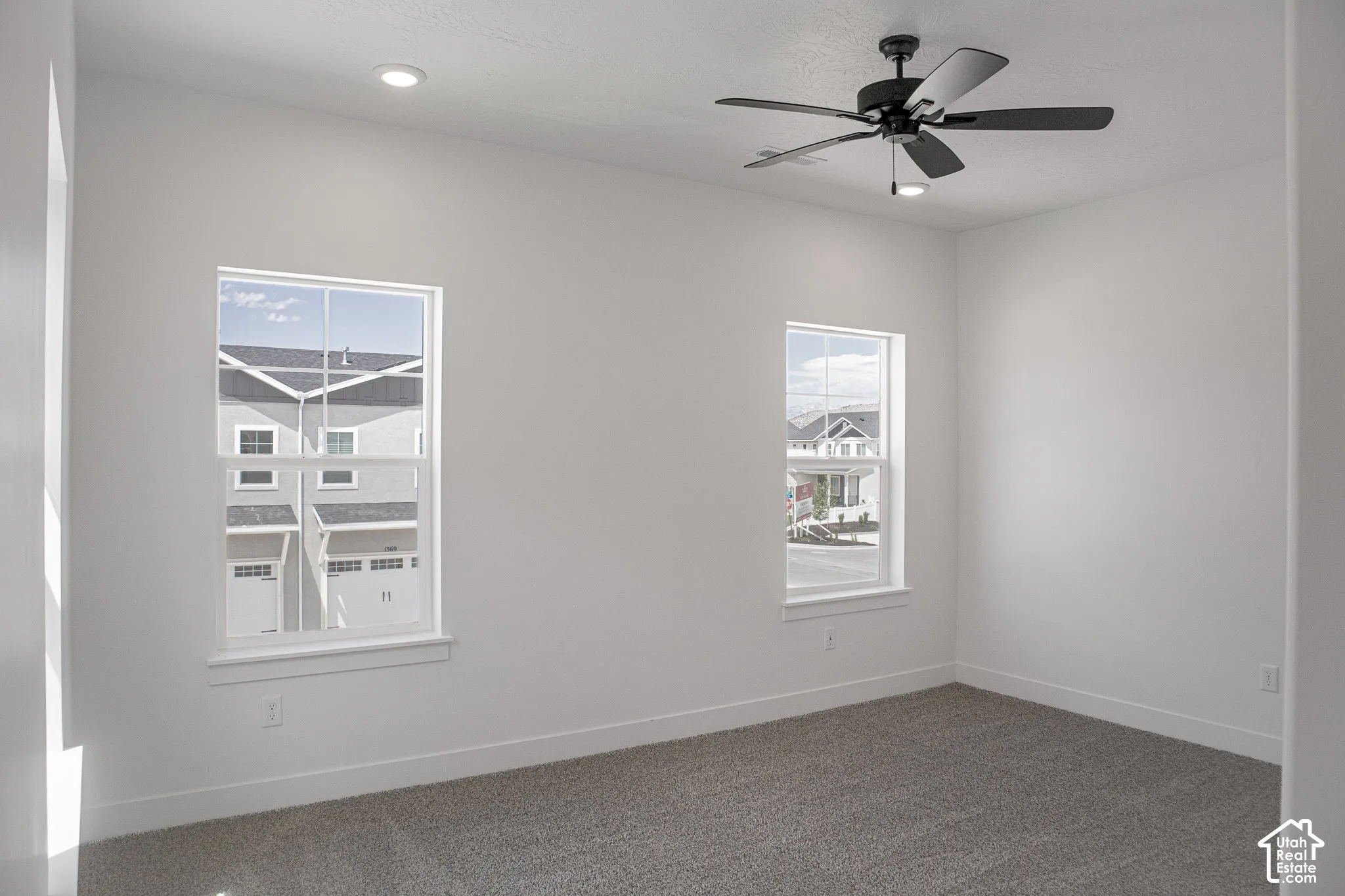 Primary bedroom with 9' ceiling and ceiling fan.