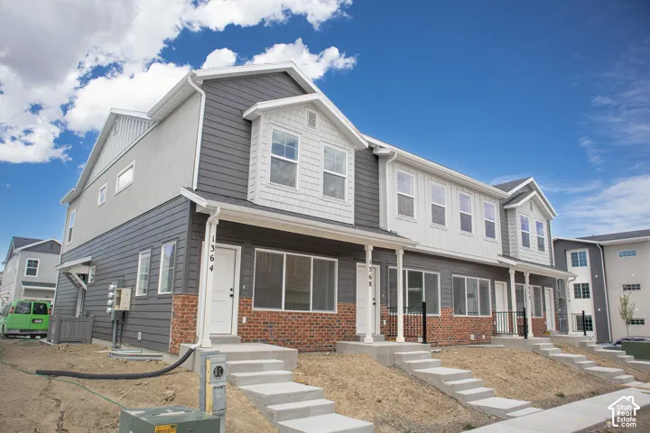 Exterior of town home with front yard and side yard landscaping to be installed.