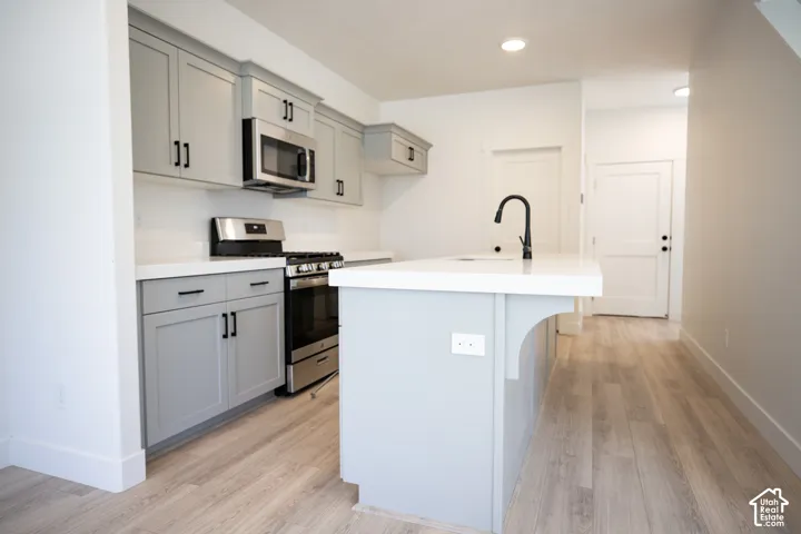 Terrific kitchen with painted wood cabinets, quartz slab countertops, walk-in pantry, gas range, microwave, dishwasher and disposal.
