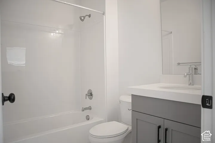 Full secondary bath with painted wood cabinet and quartz slab countertop.