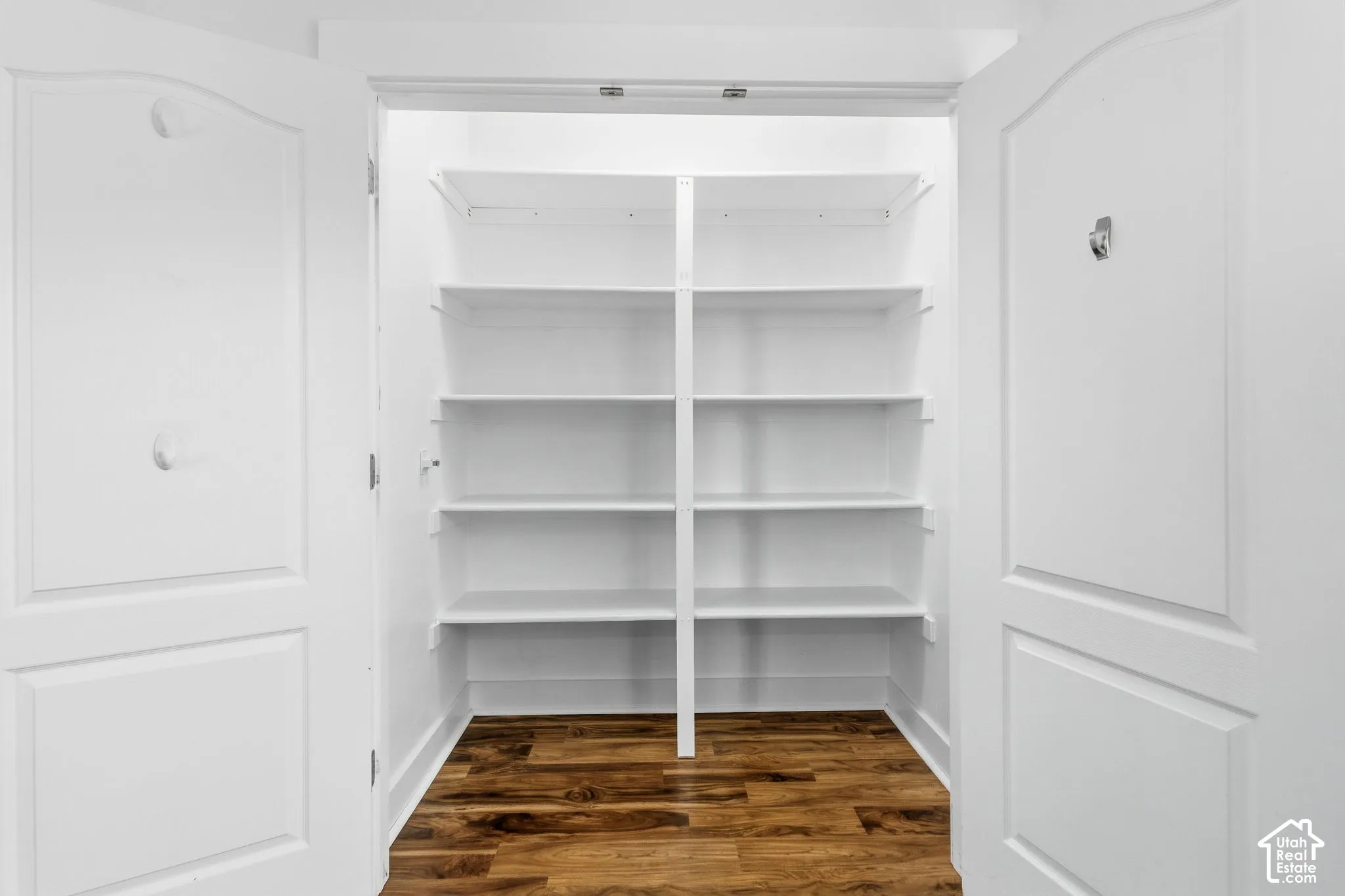 White shelving system with wood-finish flooring