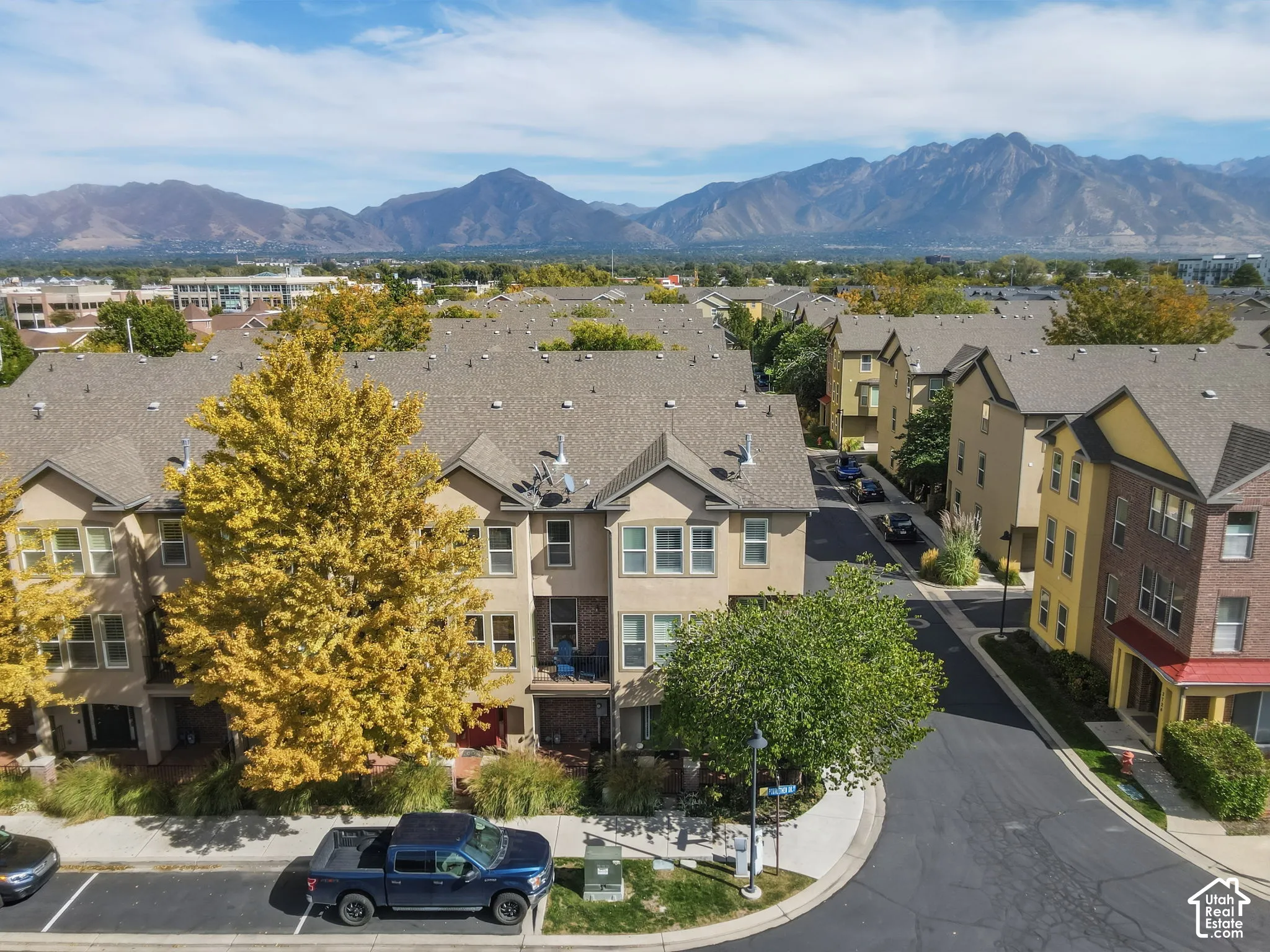 Townhome community featuring multi-story residences with pitched roofs and varied exterior finishes