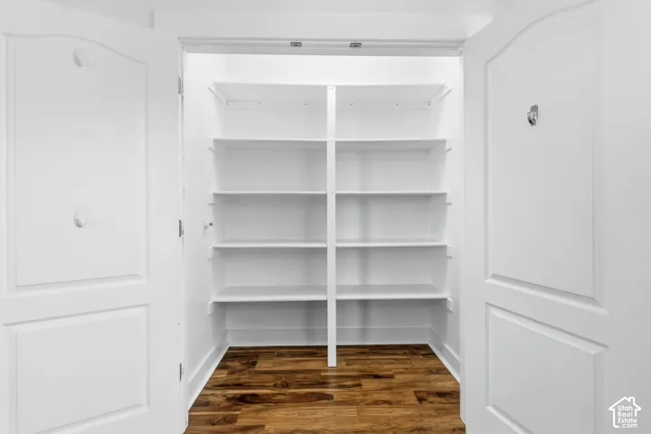 White shelving system with wood-finish flooring