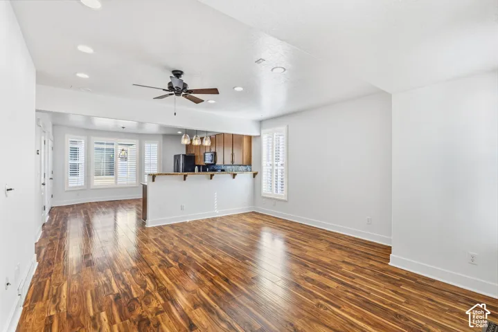 Open concept living space featuring wood-finish flooring, recessed lighting, and a ceiling fan