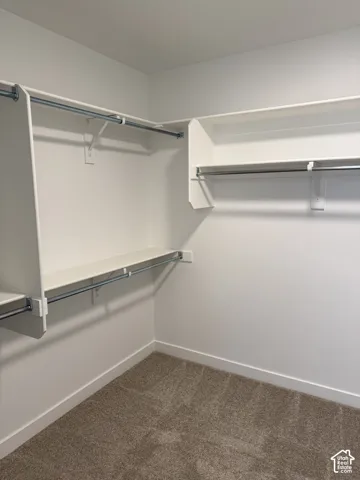 Built-in closet shelving system with multiple hanging rods and integrated storage