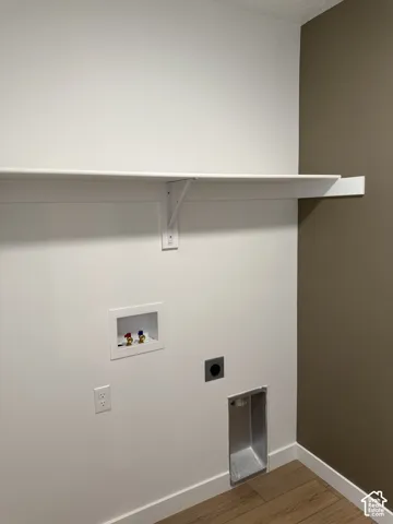 Floating white shelf, white wall finishes, accent wall, wood-finish flooring, and white trim