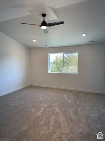 Recessed ceiling lighting, a modern ceiling fan, and a large window