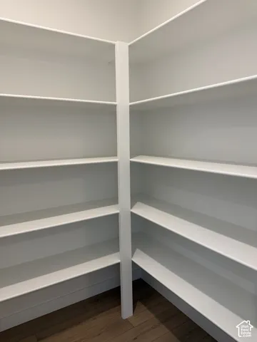 Built-in white shelving, wood-finish flooring