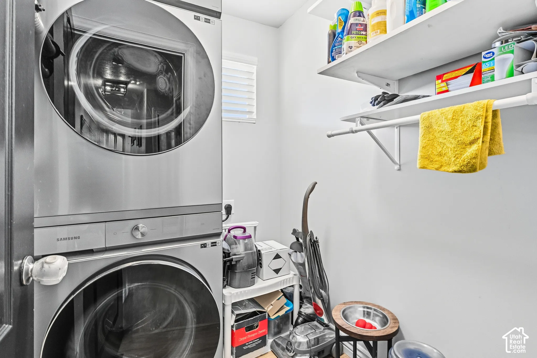 Stackable front-load washer and dryer, built-in shelving, and a hanging rod