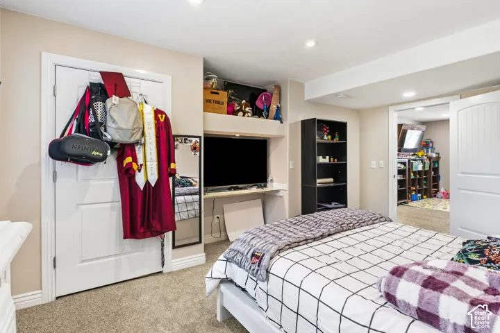 Recessed ceiling lighting, built-in shelving, white trim, and a white sliding barn door