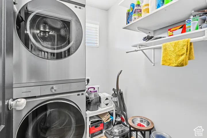 Stackable front-load washer and dryer, built-in shelving, and a hanging rod