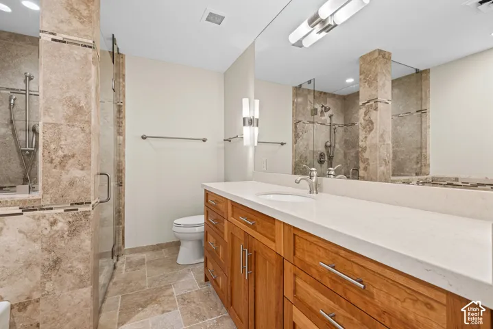 Warm wood-finish vanity with a white countertop and integrated sink