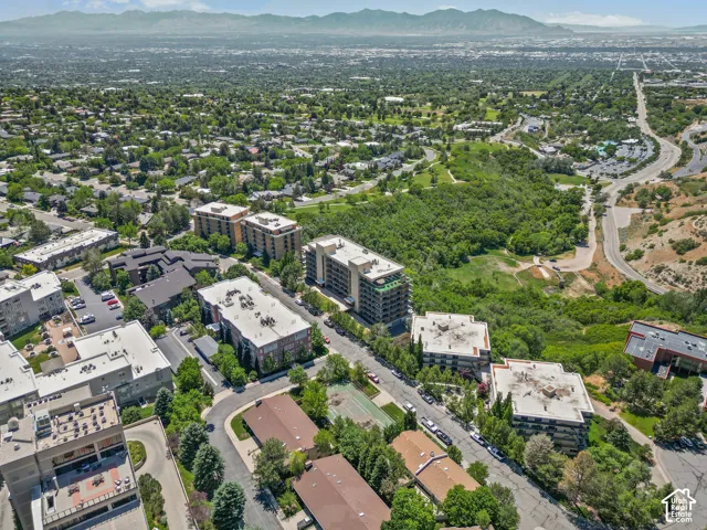 Expansive urban landscape featuring residential buildings and a mountainous backdrop