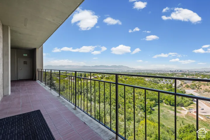 Balcony with tile flooring and black metal railing