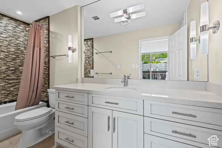 Dual vanity with white shaker-style cabinetry and a light-toned countertop