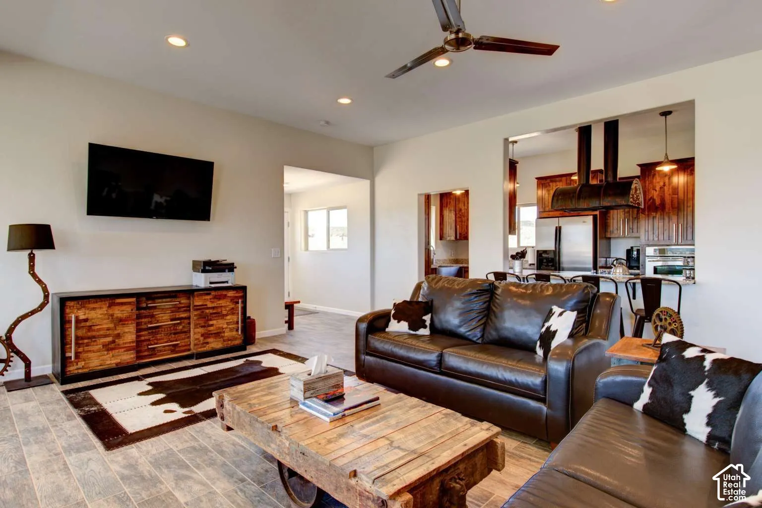 Recessed ceiling lighting, wood-finish flooring, and a ceiling fan