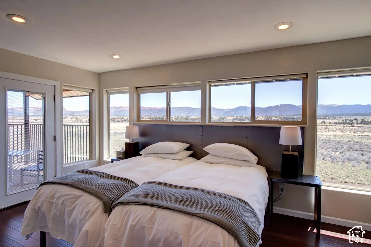 Expansive window array, recessed lighting, wood-finish flooring, and direct outdoor access