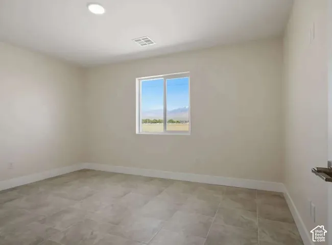 Recessed ceiling light, white window framing, mountain scenery, tile flooring, and light-toned walls