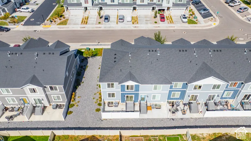 Townhome development featuring multiple units with individual patios and private fencing