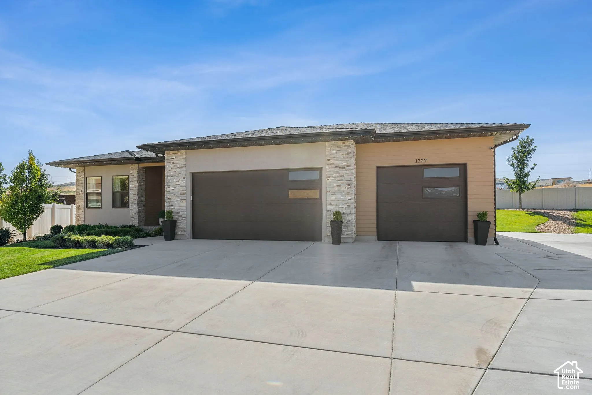 Contemporary exterior with stone facade accents and smooth stucco finish