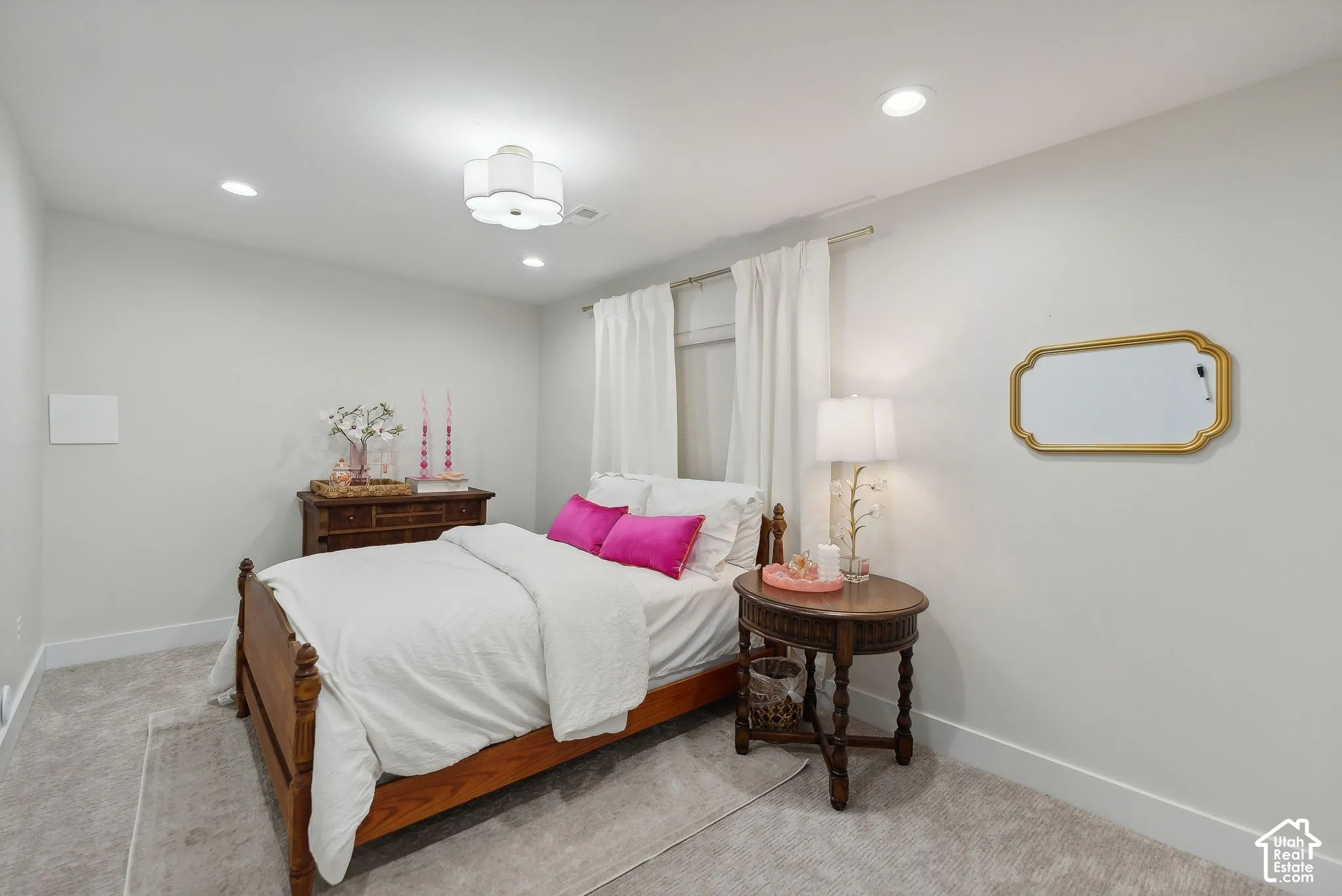 Recessed lighting and a decorative ceiling fixture illuminate the space