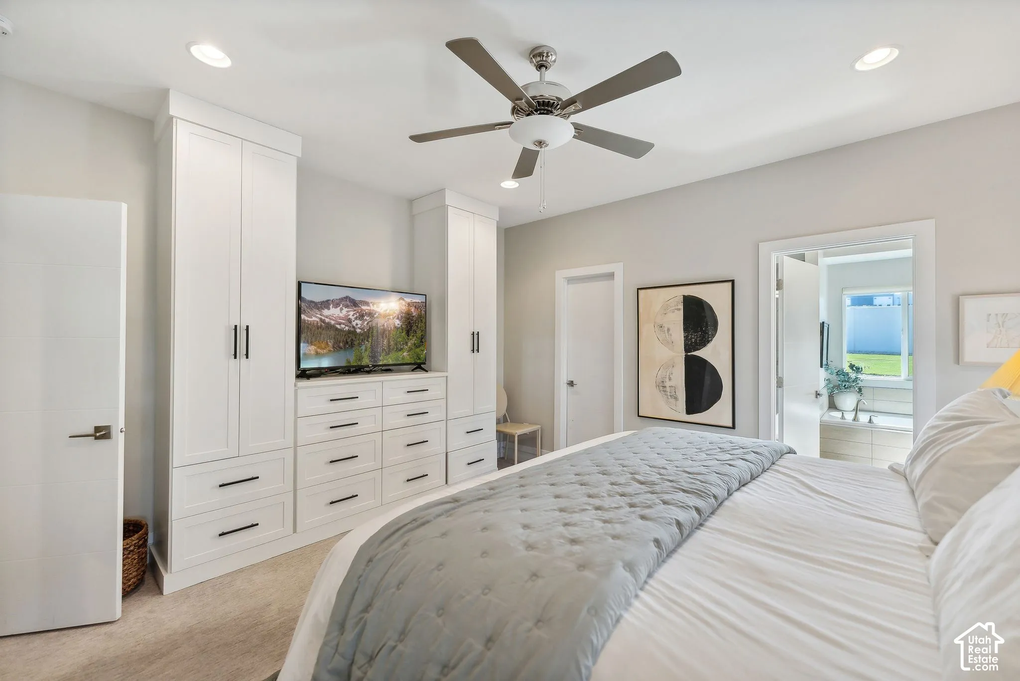 Built-in cabinetry with integrated drawers, flush-mount lighting, and ceiling fan with integrated lighting