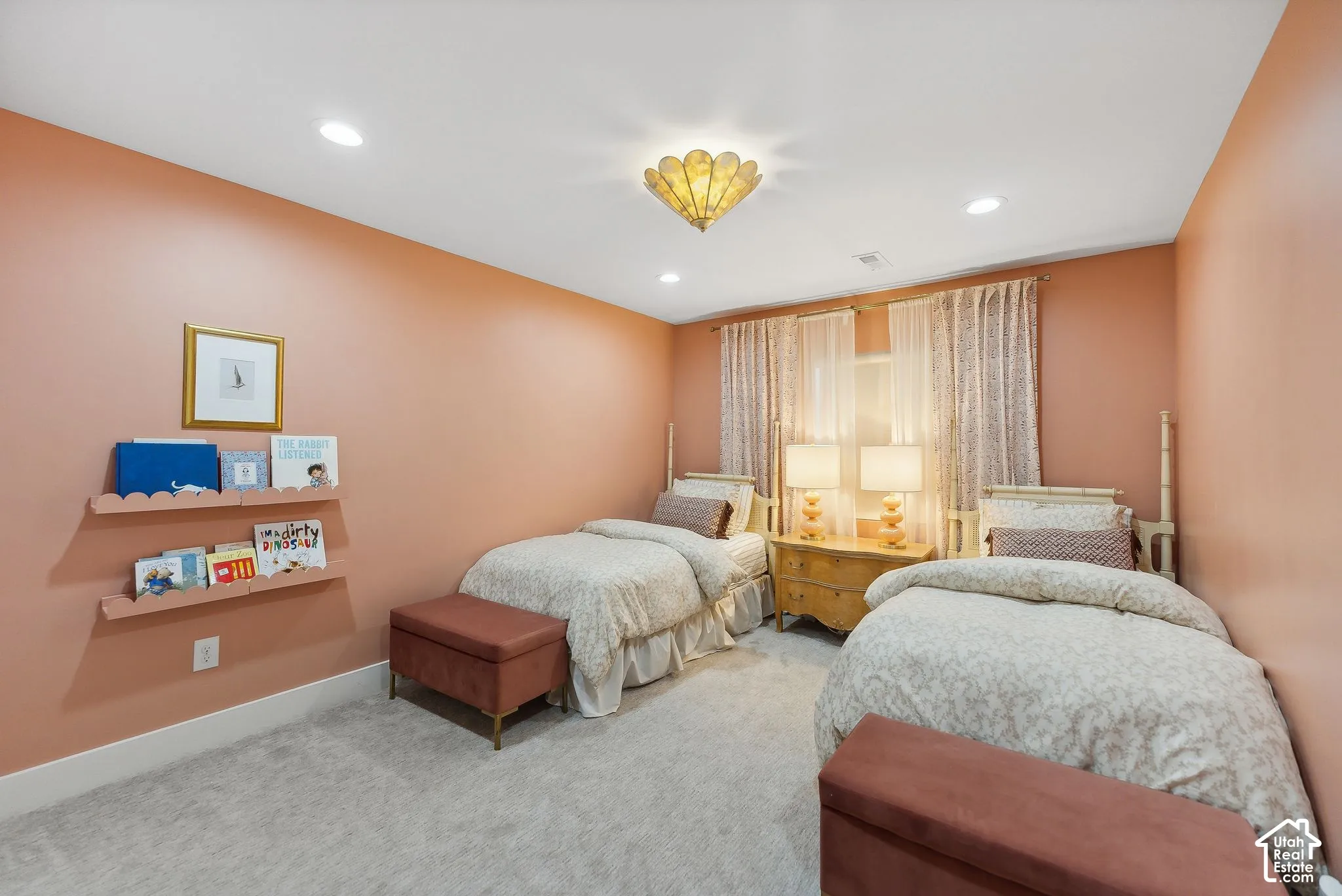 Carpeted room featuring recessed lighting, a decorative ceiling fixture, and a window with sheer and patterned drapes