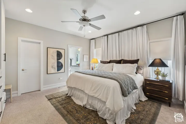 Recessed lighting, ceiling fan, and light-toned wall finishes