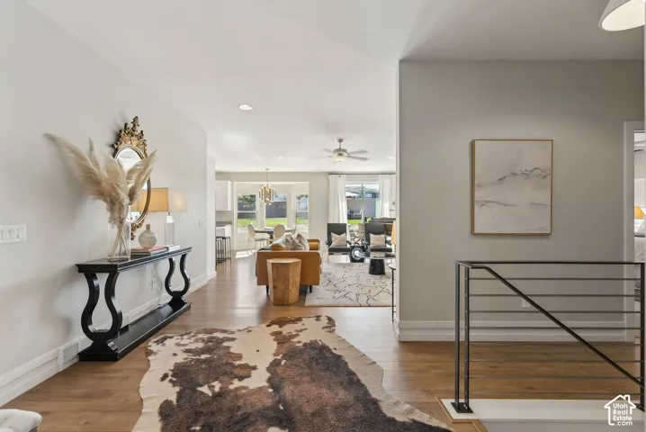 Hardwood-finish flooring, recessed lighting, and a contemporary metal railing