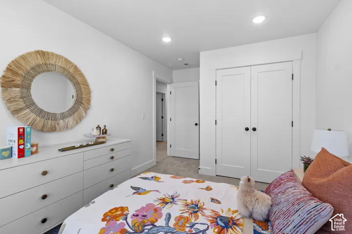 Recessed ceiling lighting, white interior doors, and neutral carpeting
