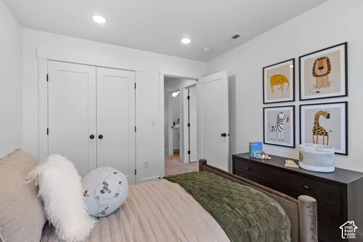 Recessed lighting, white walls, and a closet with bifold doors