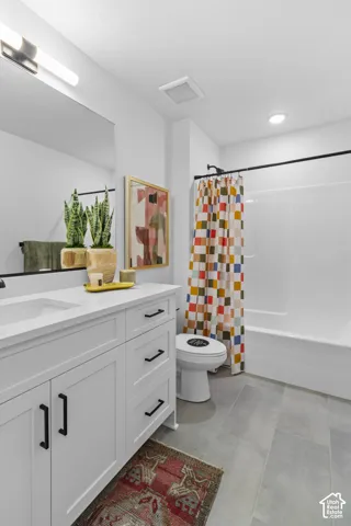 White vanity with black hardware, white countertop, and integrated sink