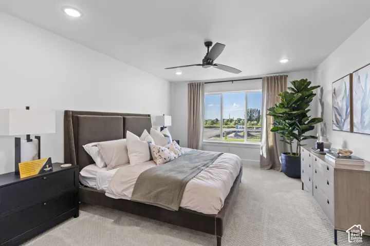Recessed lighting, ceiling fan, large window, and carpeted flooring